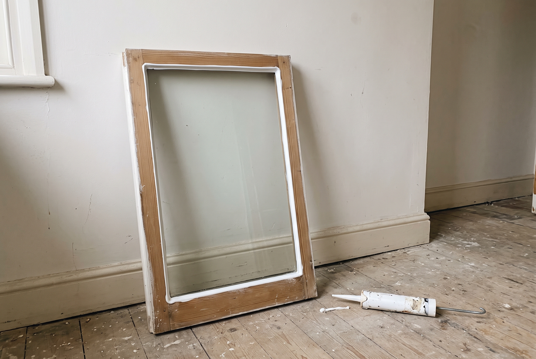 Timber sash with a fresh white glazing bead, reglazed without putty