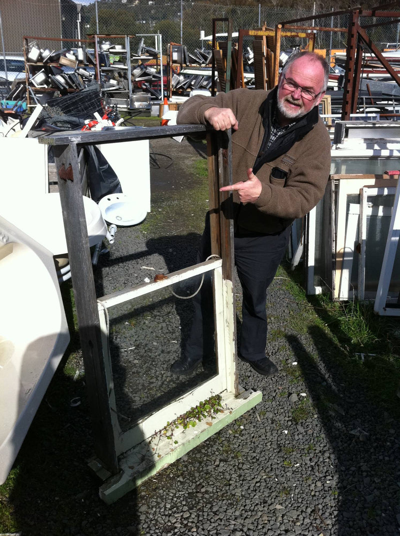 Colm, co-founder of Sealasash, with an old sash window at the tip shop in 2011